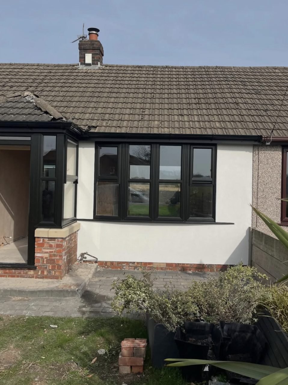 Bungalow with smooth white render next to a pebbledashed neighbour